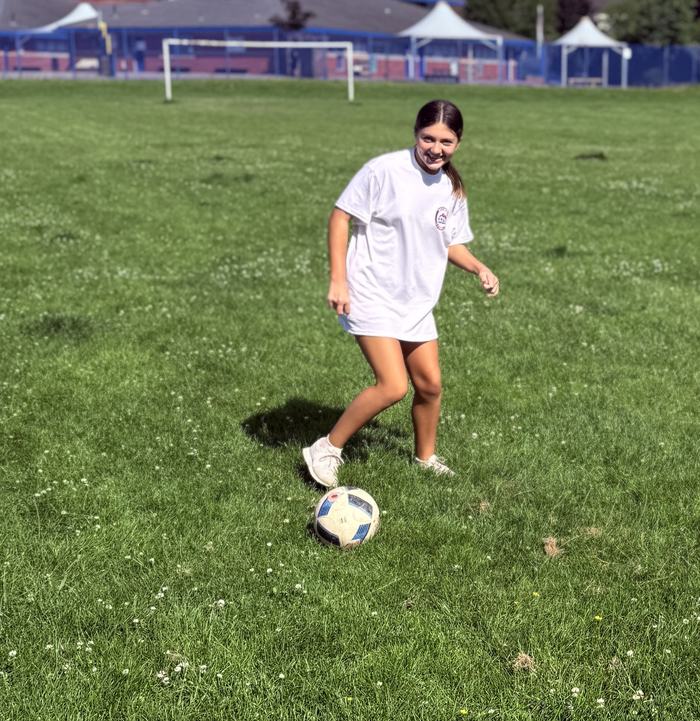 Young Costa Ballers player smiling mid-drill