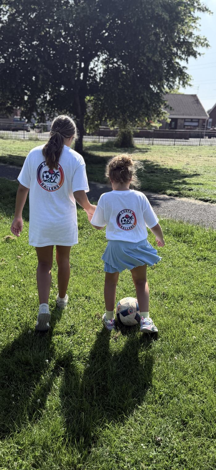 Two players walking off the pitch together after a session